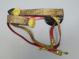 a red and gold belt with gold buttons on it