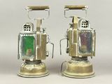 two old fashioned lanterns sitting on top of each other