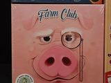 two books that are on a table with a pig on it