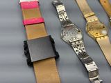 several different watches are lined up on a table