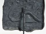 statue of a man with a mustache on a stone block