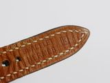 brown leather watch strap with white stitching on a white background