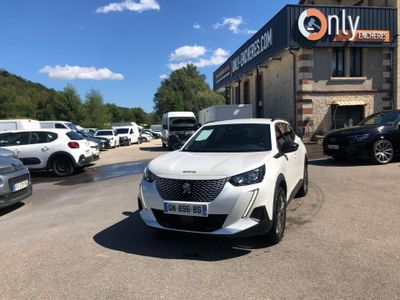 a white car parked in front of a building