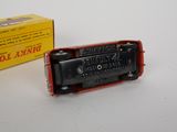 a black and red toy train sitting next to a yellow box