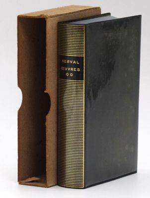 an old book with a black cover sitting inside of it