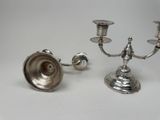 pair of silver plated candlesticks on a white background