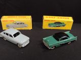 three toy cars are sitting next to each other on a table