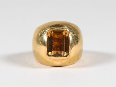 an image of a gold ring with a brown stone in the center