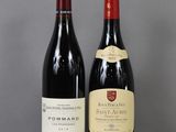 two bottles of wine sitting next to each other on a table