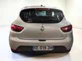 a silver car that is parked in a white room