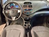 dashboard of a small car with a steering wheel and dashboard controls