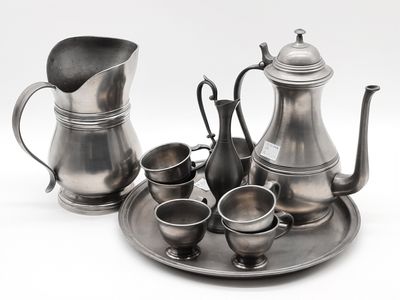 a silver tea set on a silver tray on a white background