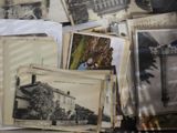 a pile of old photographs on a table