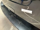 a sticker on the bumper of a car that has been dented