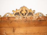 an old wooden box with a carved design on top of it