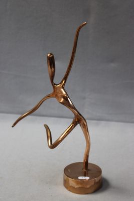 bronze sculpture of a woman holding a tennis racquet on a base