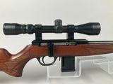 a rifle with a scope mounted on top of it