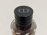 a small bottle of liquid sitting on a table
