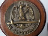 two wooden buttons with a metal eagle on them sitting on a table