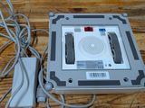 a silver electronic device sitting on a wooden table