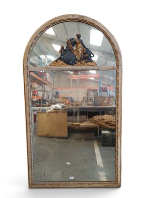 an image of a large mirror with a statue on top of it