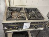 a gas stove with a sign on it in a kitchen