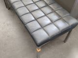 a bench that is sitting in a room with a wall behind it