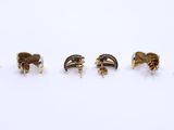 a set of five gold and silver rings on a white surface