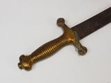 a sword that is laying on a white surface