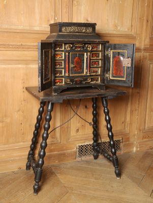 a small wooden table with a small cabinet on it