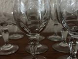 several empty wine glasses sitting on top of a wooden table