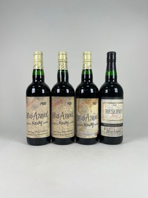 three bottles of wine sitting on top of a white table