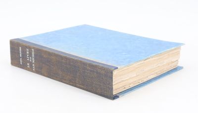a blue book sitting on top of a white table