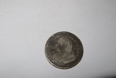 a close up of a coin on a table with a white background