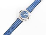 a close up of a watch on a white surface with a blue strap