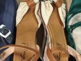 three pairs of shoes that are sitting on a box