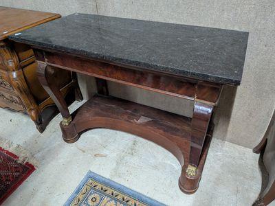 a small table with a black marble top on it