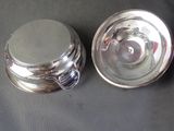 a silver plate with a lid and a silver plate with a lid