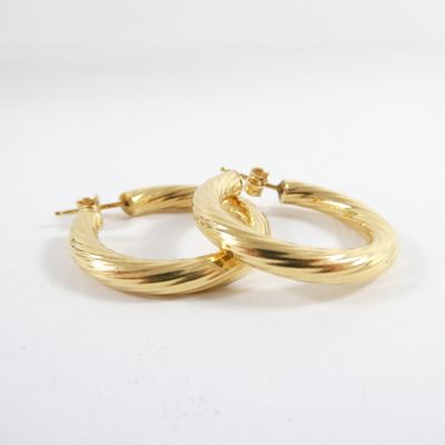 a pair of gold hoop earrings on a white background