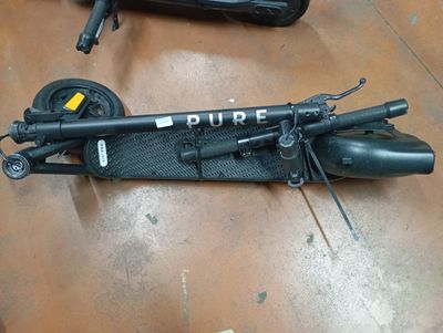 a scooter that is sitting on the floor next to a suitcase