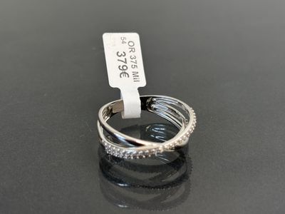 a close up of a diamond ring on a table with a price tag