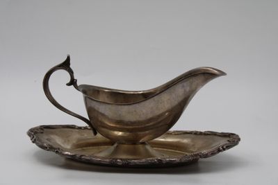 an antique silver plate with a saucer and saucer on it