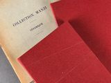 two red books sitting on top of a table next to each other