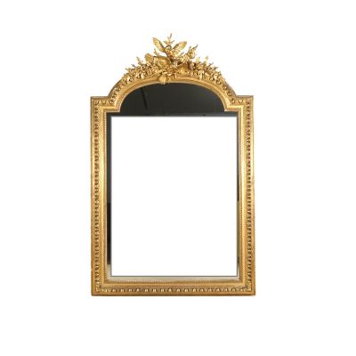 an image of a gold framed mirror on a white wall
