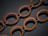 a close up of a chain with wooden rings on it