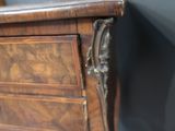 a close up of a wooden cabinet with a metal handle