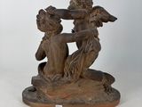 an image of a statue of two cherensils on a base