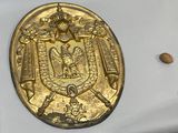 a gold coin with a coat of arms and a crown on it