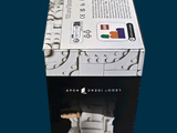a box of puzzle pieces with a picture of a bed