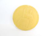 a yellow coin with a picture of a woman on it